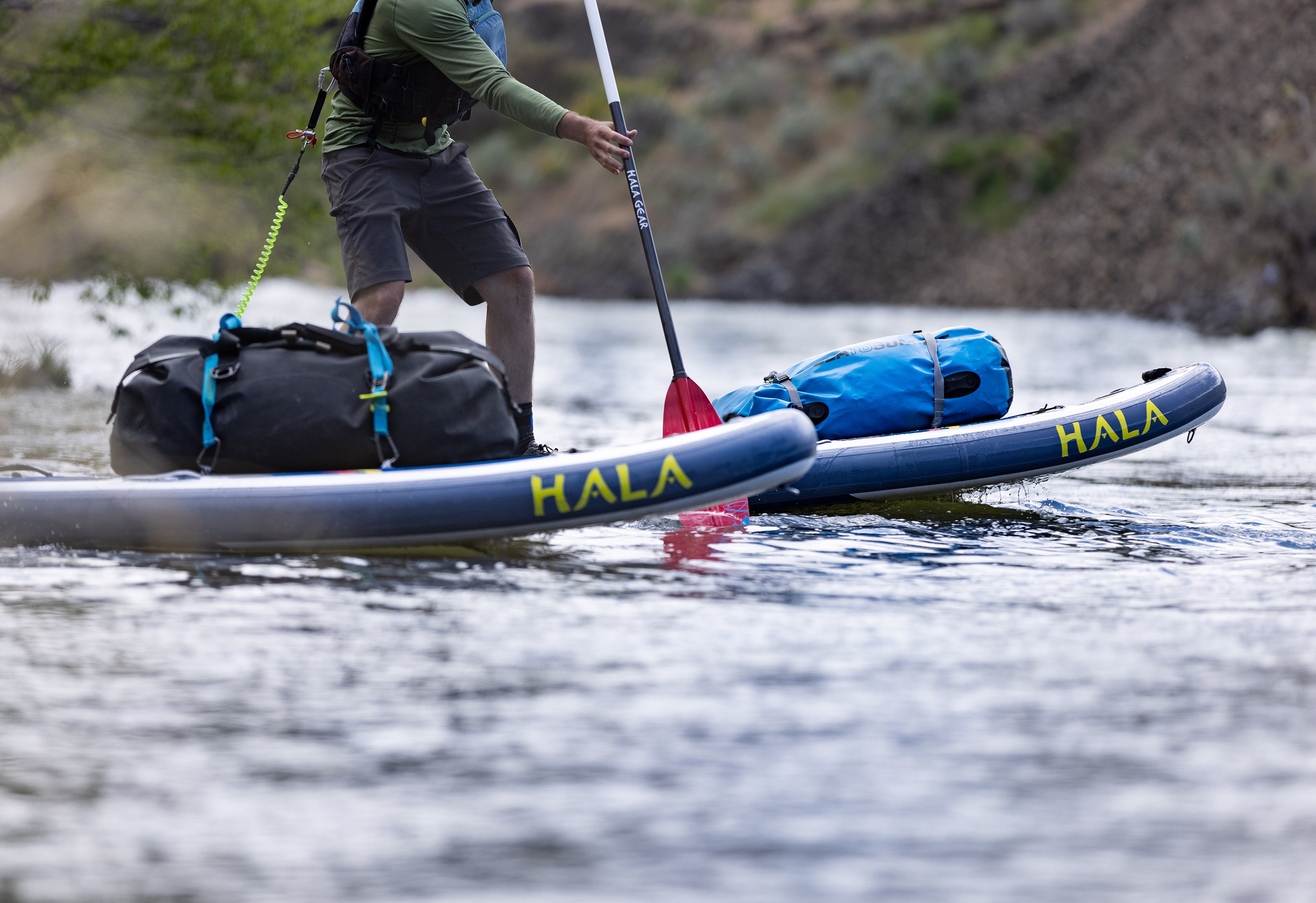     Query successful  A pair of Hala inflatable stand-up paddleboards (SUPs) are loaded with gear for a multi-day river trip.