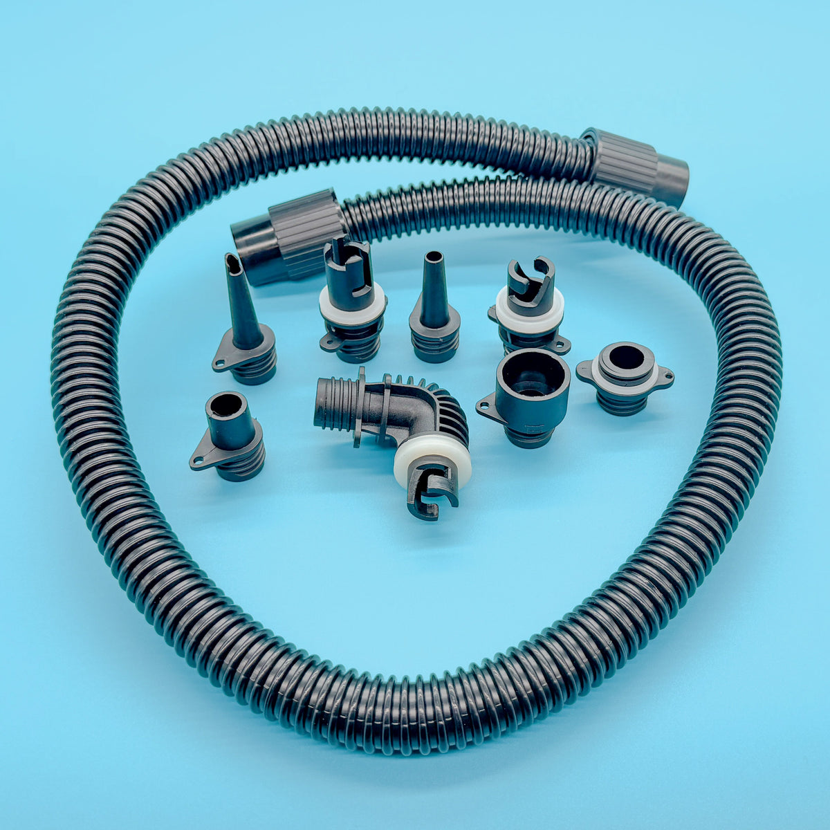 Coiled inflation hose and the full set of black valve nozzle adapters included with the Hala cordless electric SUP pump.